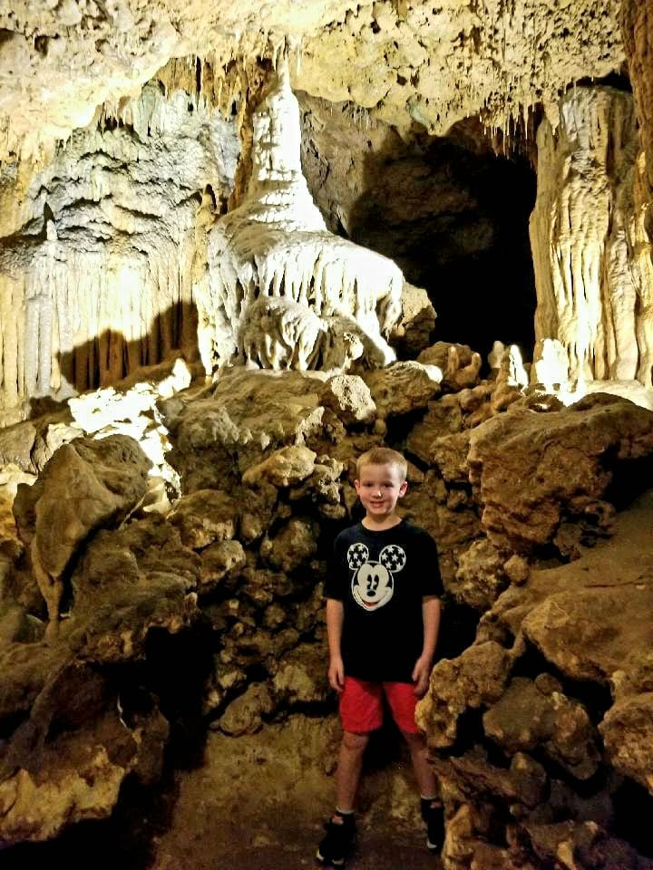 Boy full of curiosity on a cave tour