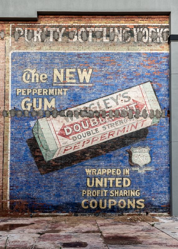 A building mural from the early 1900's for Purity Bottling Works featuring an ad for Doublemint Gum