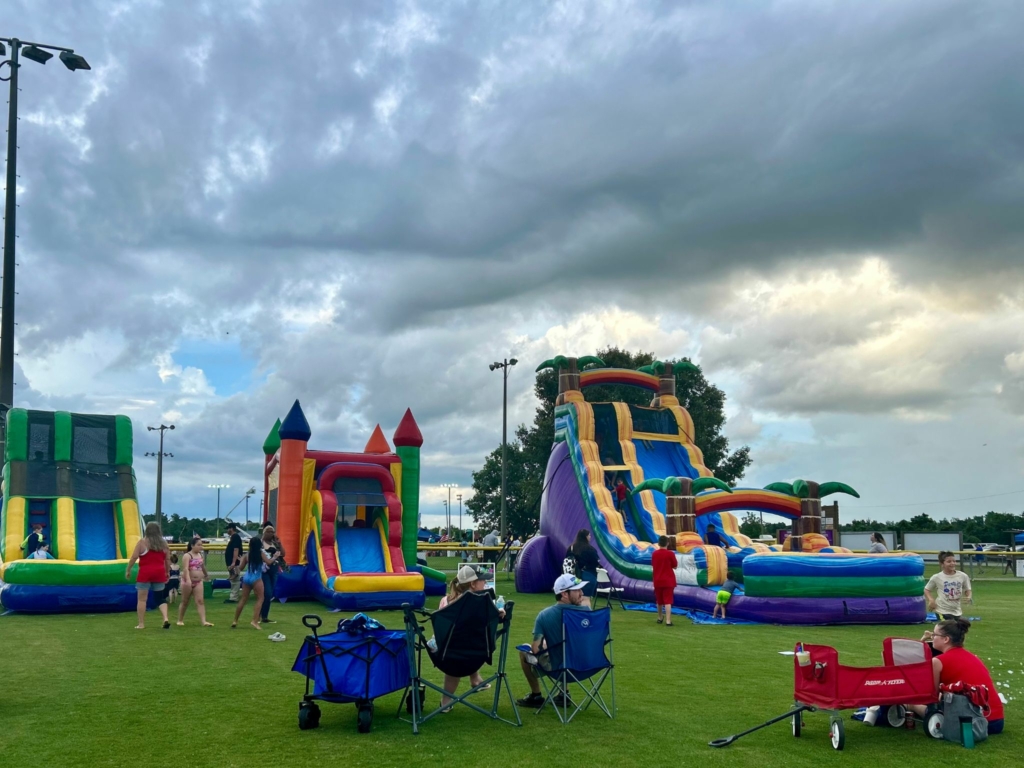 Kid's bounce houses in front of a cloudy sky