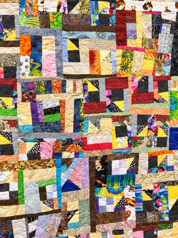 A crumb quilt at a Florida Shop Hop stop features all different sized blocks with all different colors and prints.
